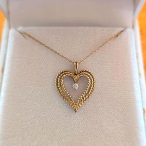 Vintage 8 karat gold and diamond pendant on 14 karat gold chain.